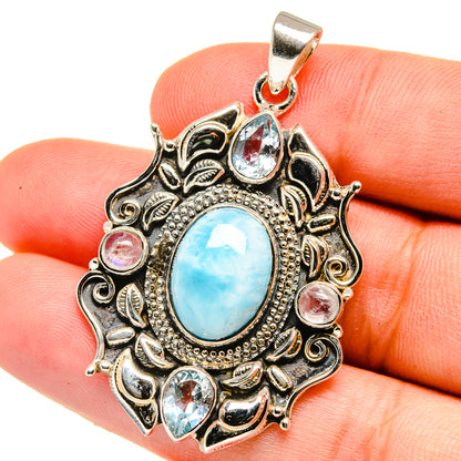 Oval blue larimar center pendant with blue stones and sterling silver filigree border