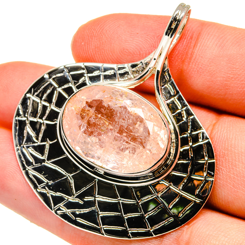 Sterling silver pendant with round rose quartz cabochon and black enamel frame