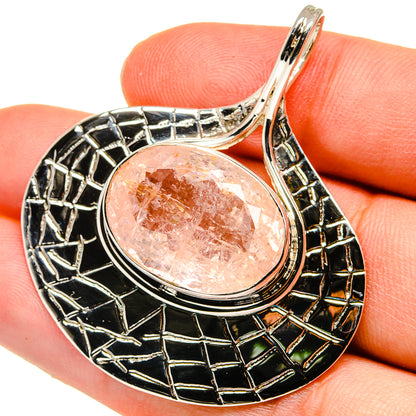 Sterling silver pendant with round rose quartz cabochon and black enamel frame