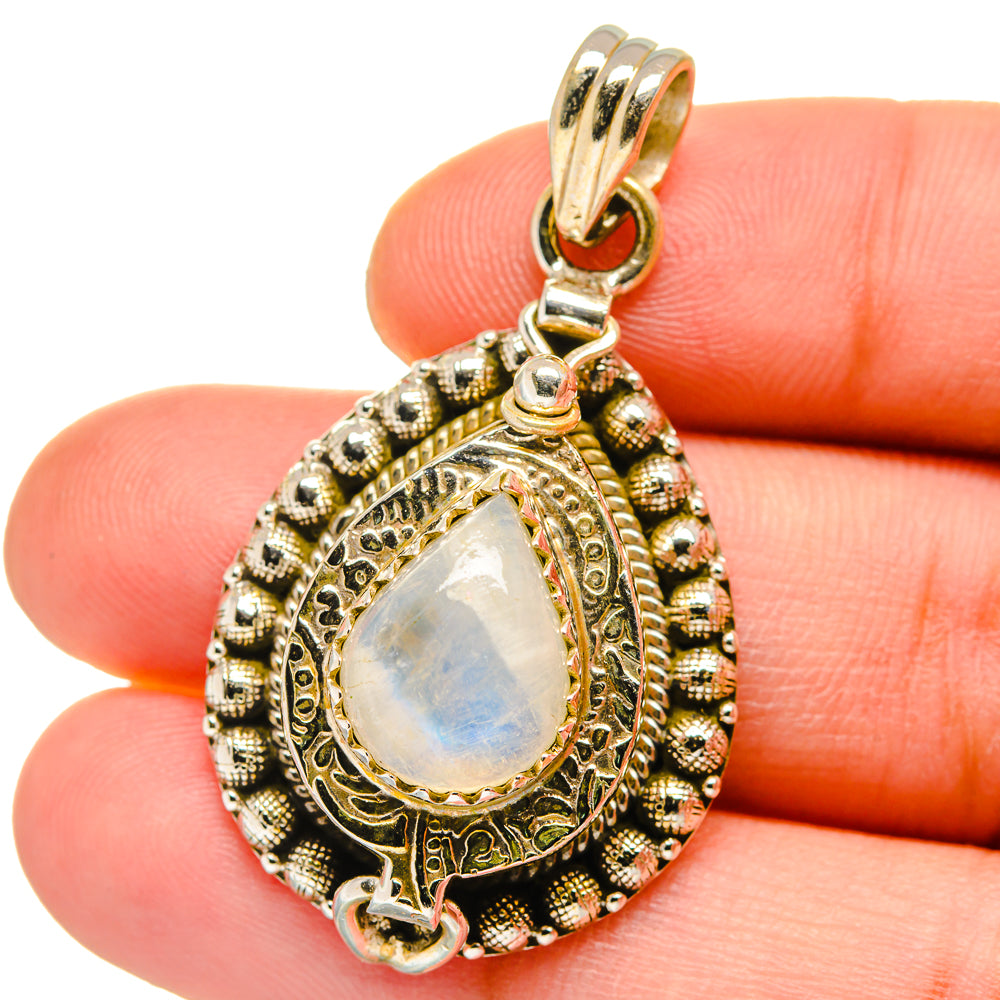 Teardrop sterling silver pendant with iridescent moonstone-like center