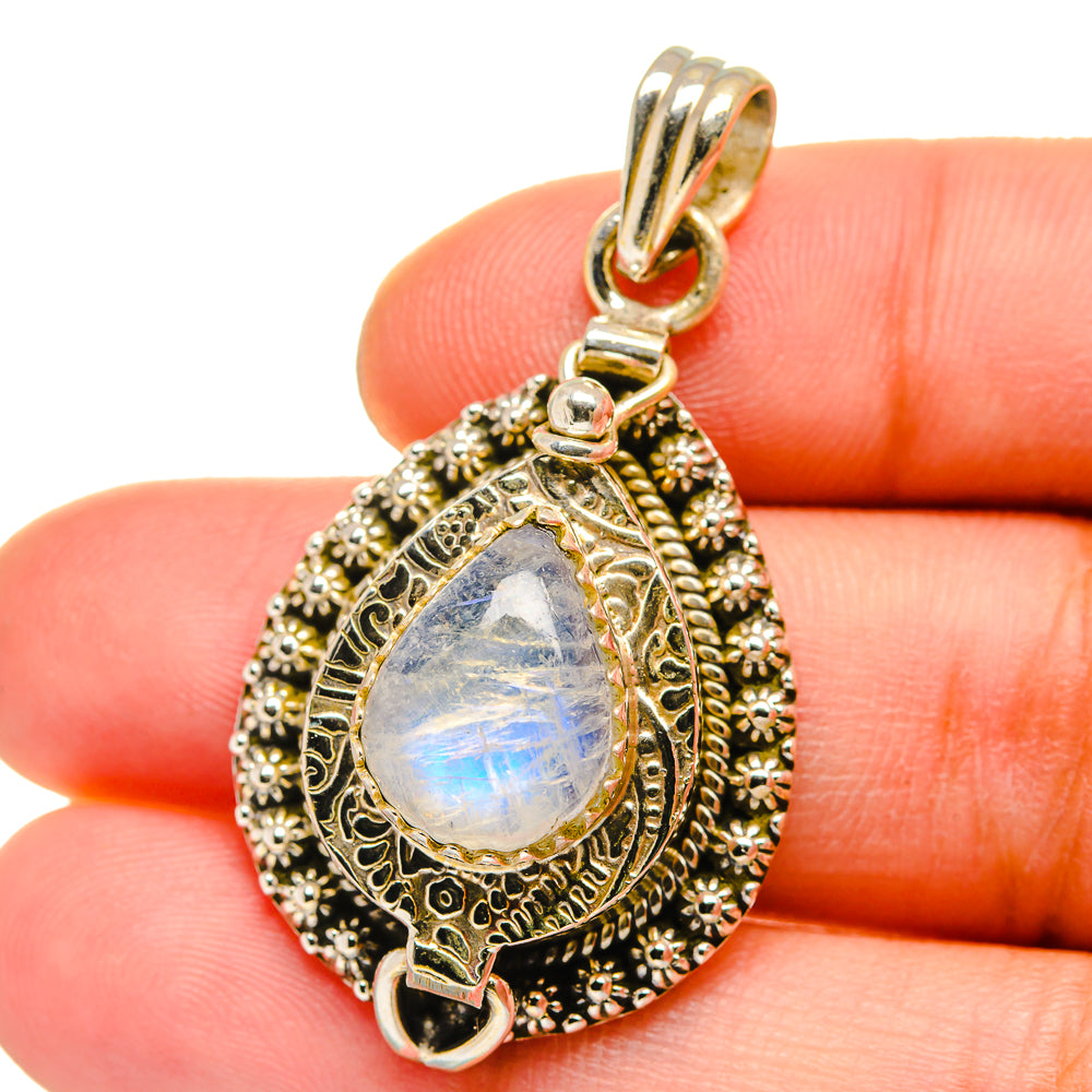 Sterling silver poison pendant with teardrop rainbow moonstone and ornate gold-tone bezel