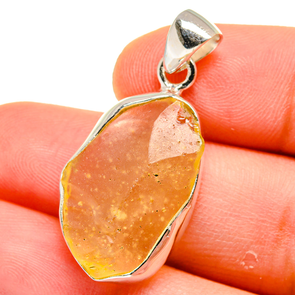 Sterling silver Libyan Desert Glass pendant with oval amber/orange stone and bail