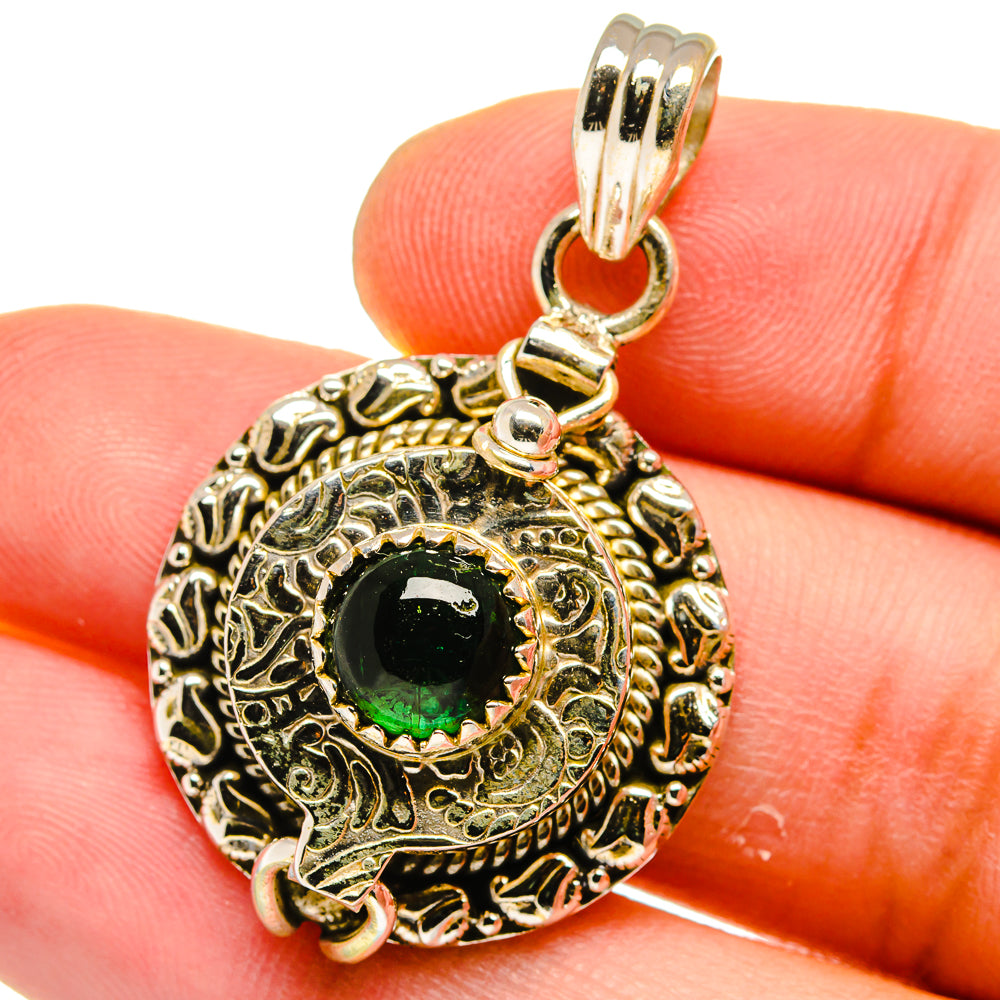 Poison pendant close-up with green aventurine in engraved sterling silver bezel