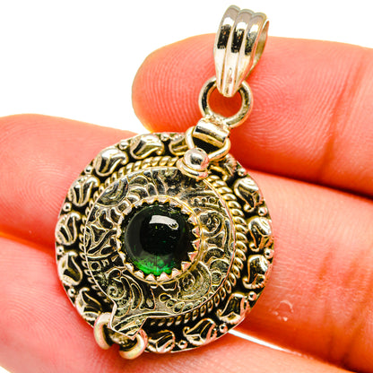 Poison pendant close-up with green aventurine in engraved sterling silver bezel