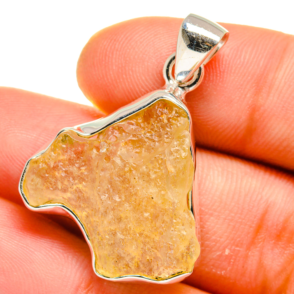 Libyan Desert Glass pendant with irregular orange stone in sterling silver bezel