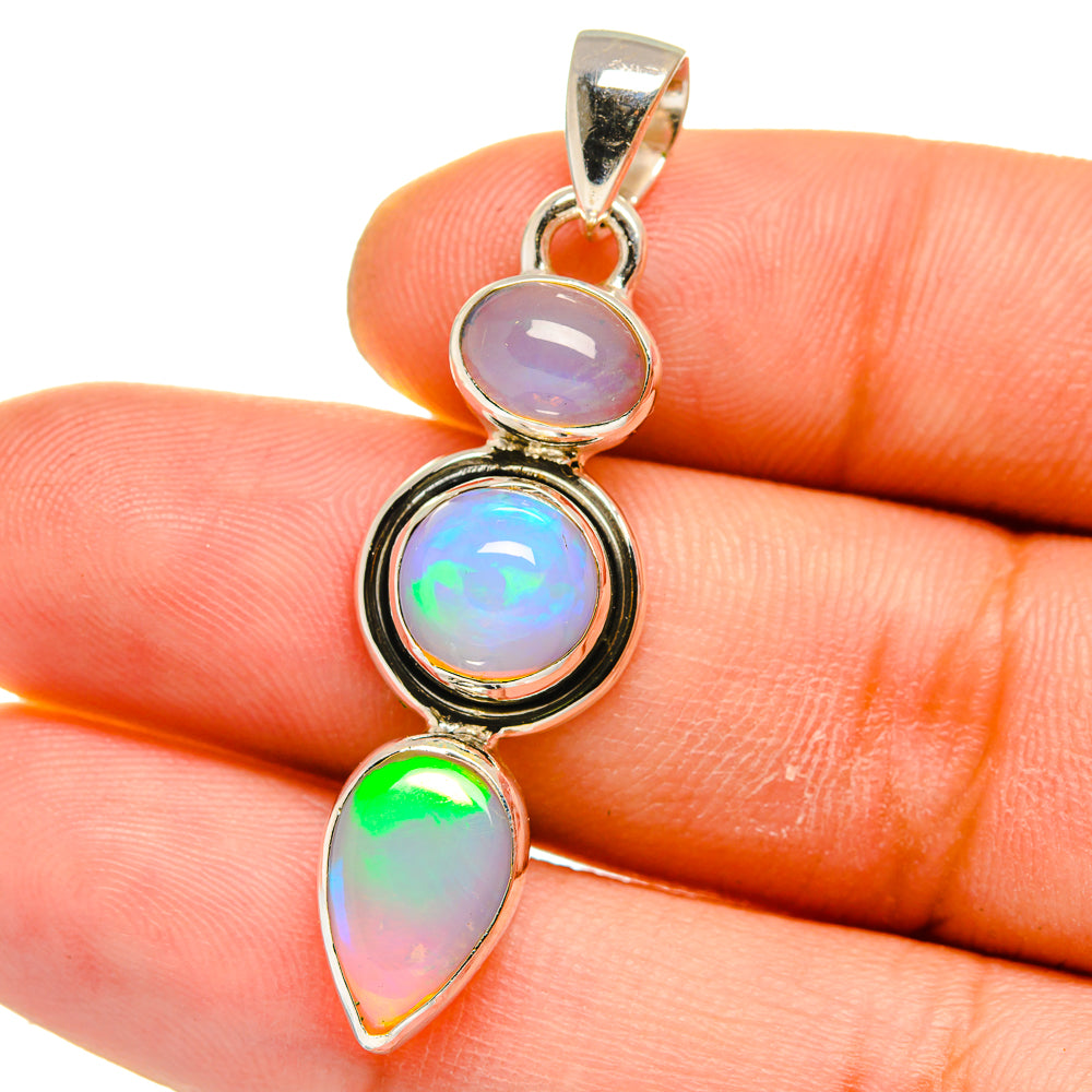 925 sterling silver Ethiopian opal pendant with round bezel and teardrop opals, colorful shimmer.