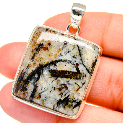 Square sterling silver pendant with black and gold streaks in white gemstone.