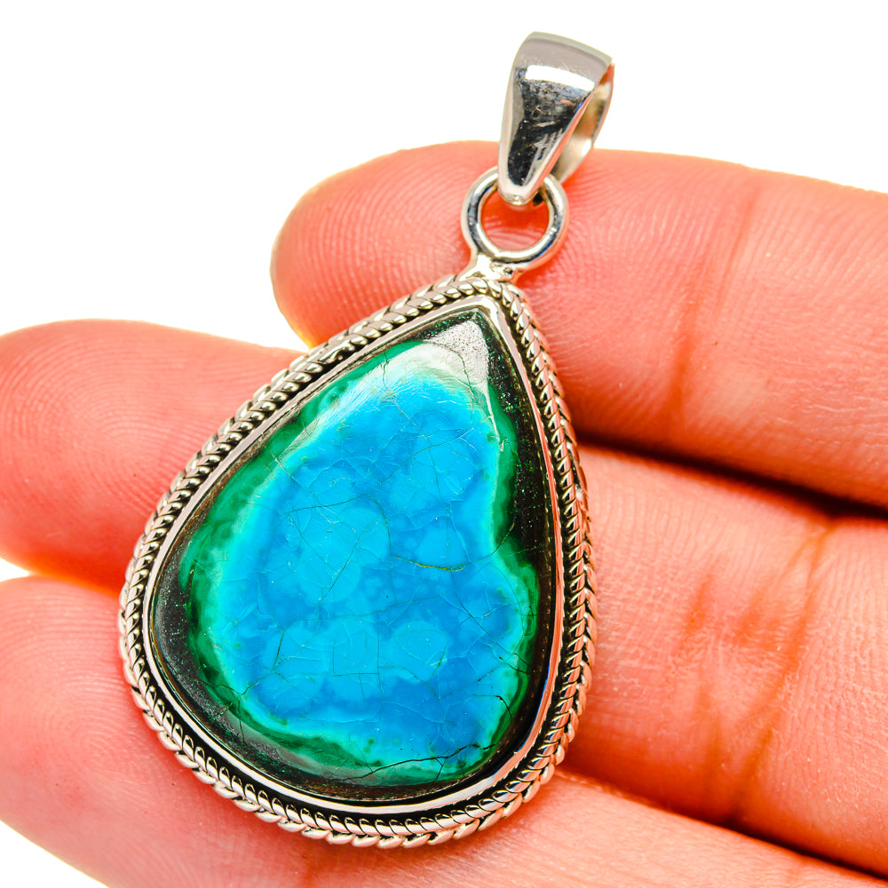 Sterling silver pendant close-up on fingers, teardrop blue-green cabochon stone