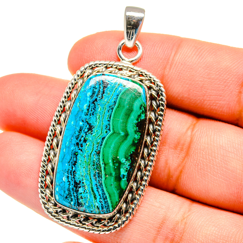 Blue-green marbled gemstone pendant with braided silver border and top bail