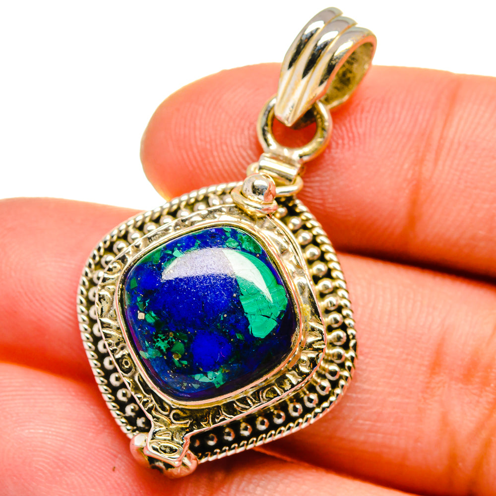 Blue-green stone pendant held in hand, ornate gold-tone 925 silver frame