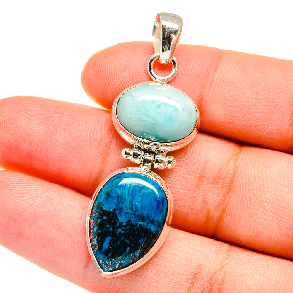Two-stone oval pendant on hand: light blue and dark blue cabochons in sterling silver