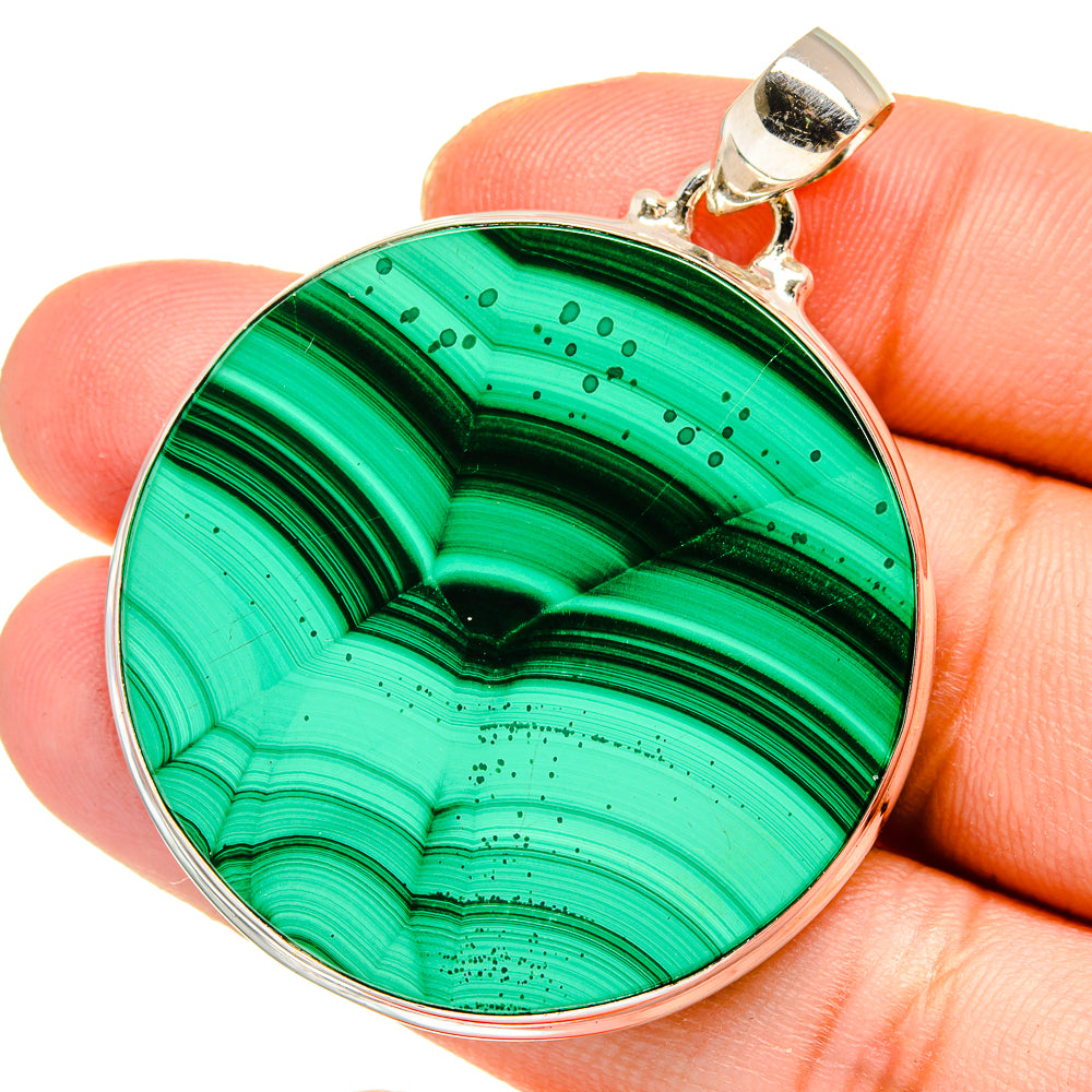 Round malachite pendant with silver bezel and loop bail, vivid green striped stone.
