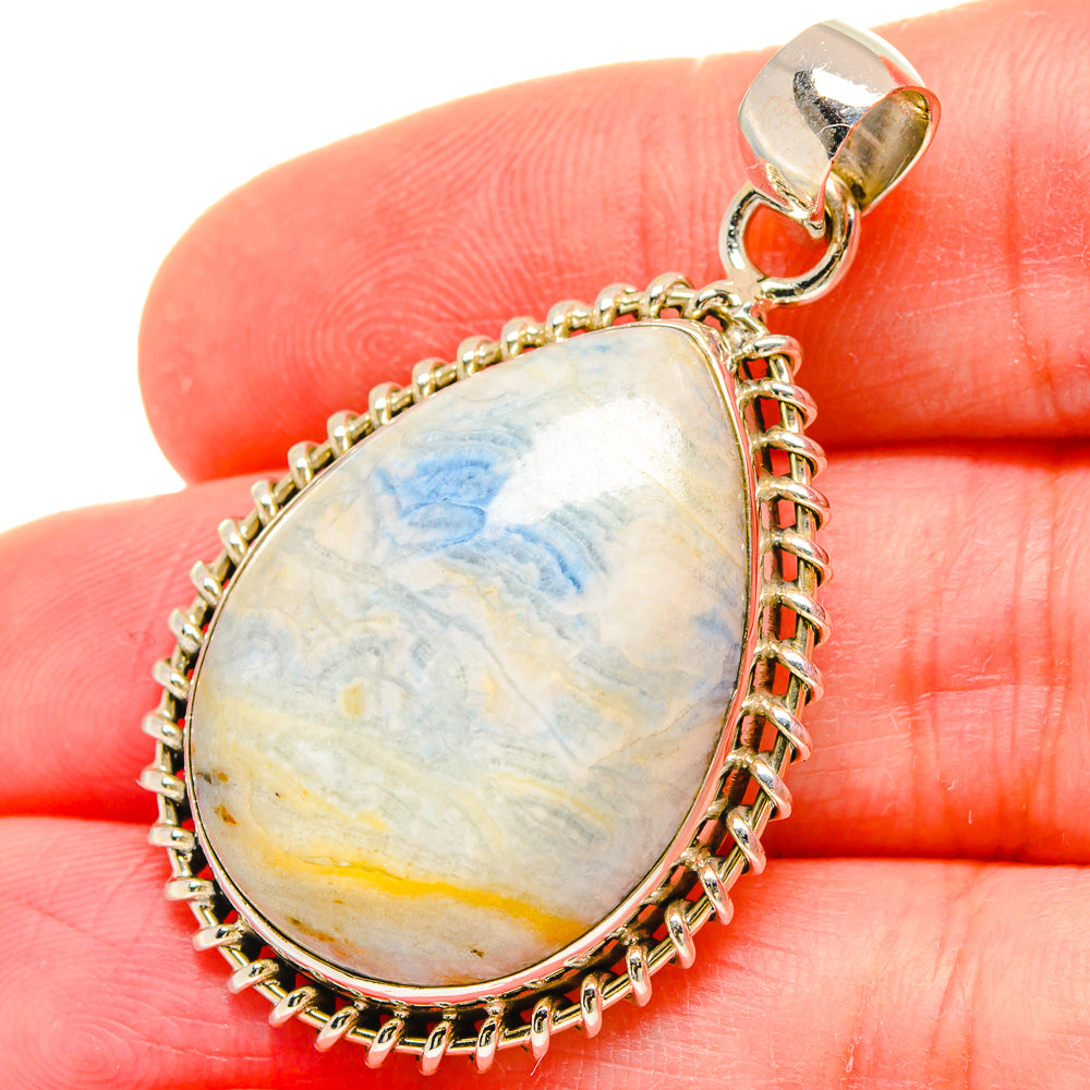 Blue scheelite teardrop pendant with silver bail and rope-edge frame, 925 sterling