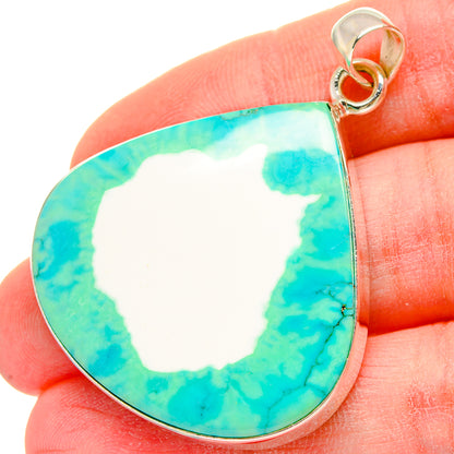 Close-up green howlite pendant with teardrop turquoise stone and silver bail