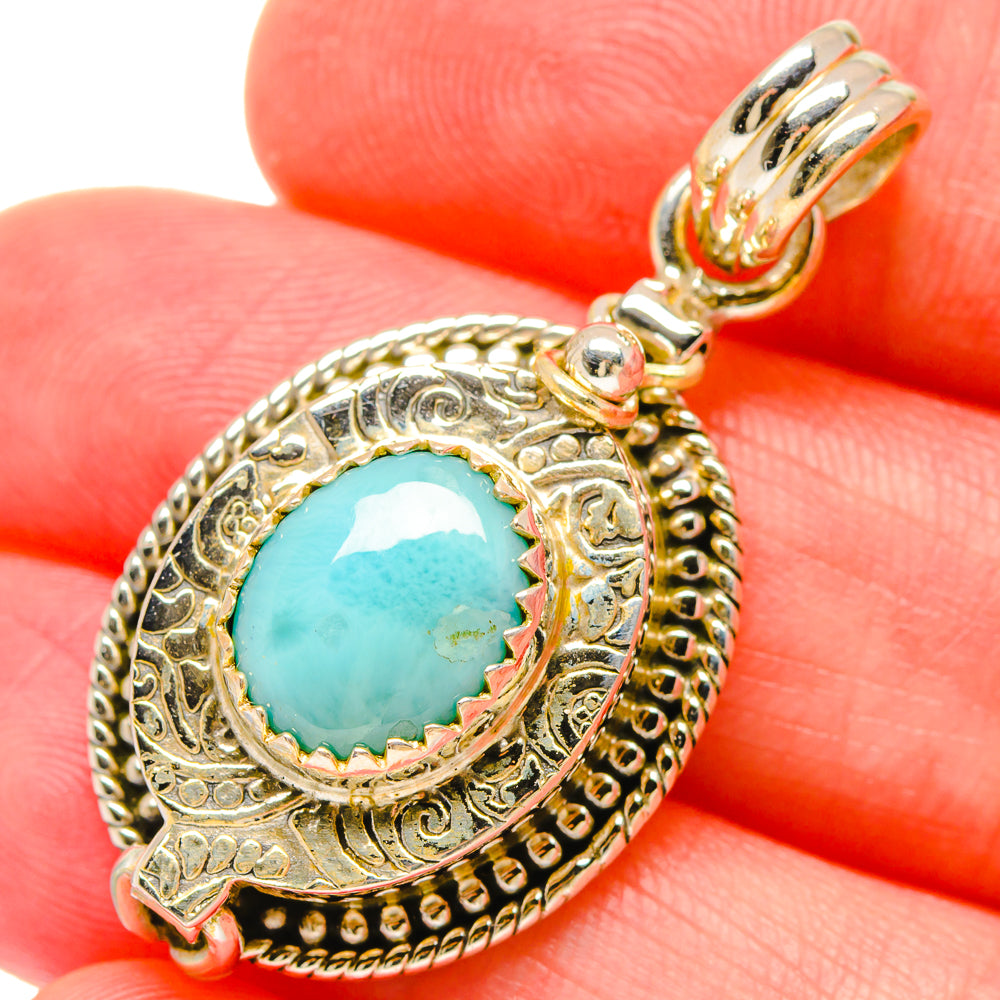 Close-up of larimar pendant: turquoise stone in filigree 925 sterling silver bezel