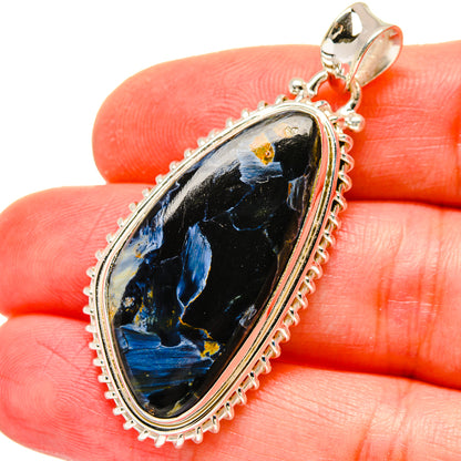 Oval pietersite pendant with dark stone and blue streaks in sterling silver setting