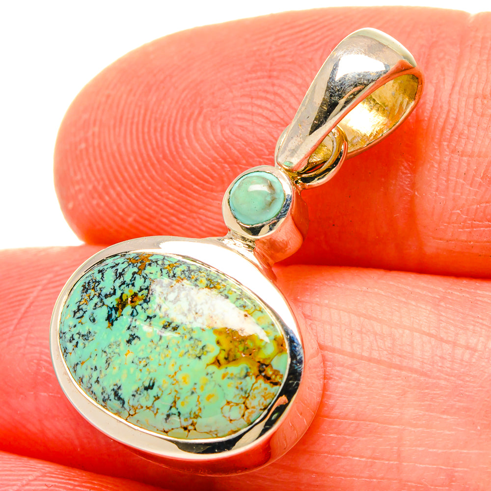 Gold-tone turquoise pendant with oval stone and small round turquoise centerpiece