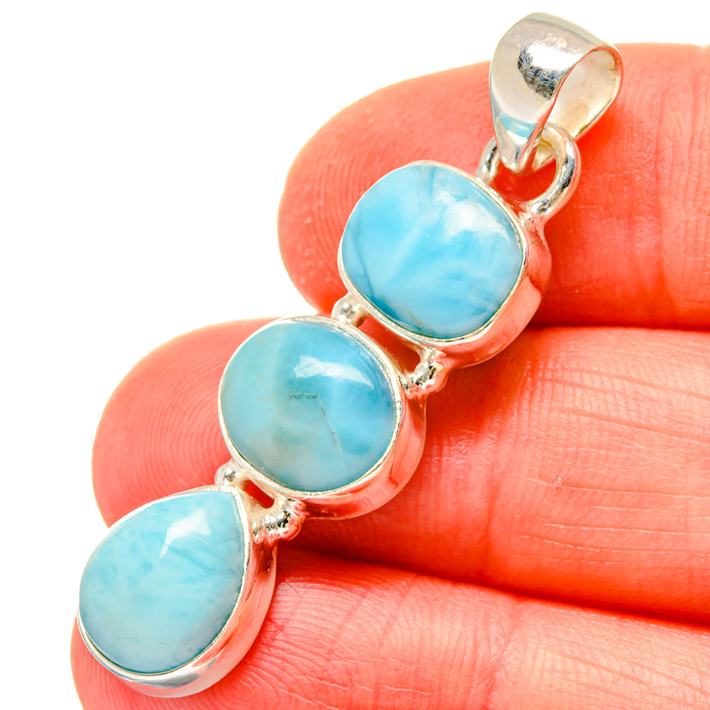 Larimar pendant close-up: three oval blue stones in sterling silver settings