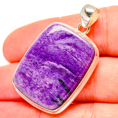 Purple charoite rectangular pendant with 925 sterling silver bezel, shown on hand