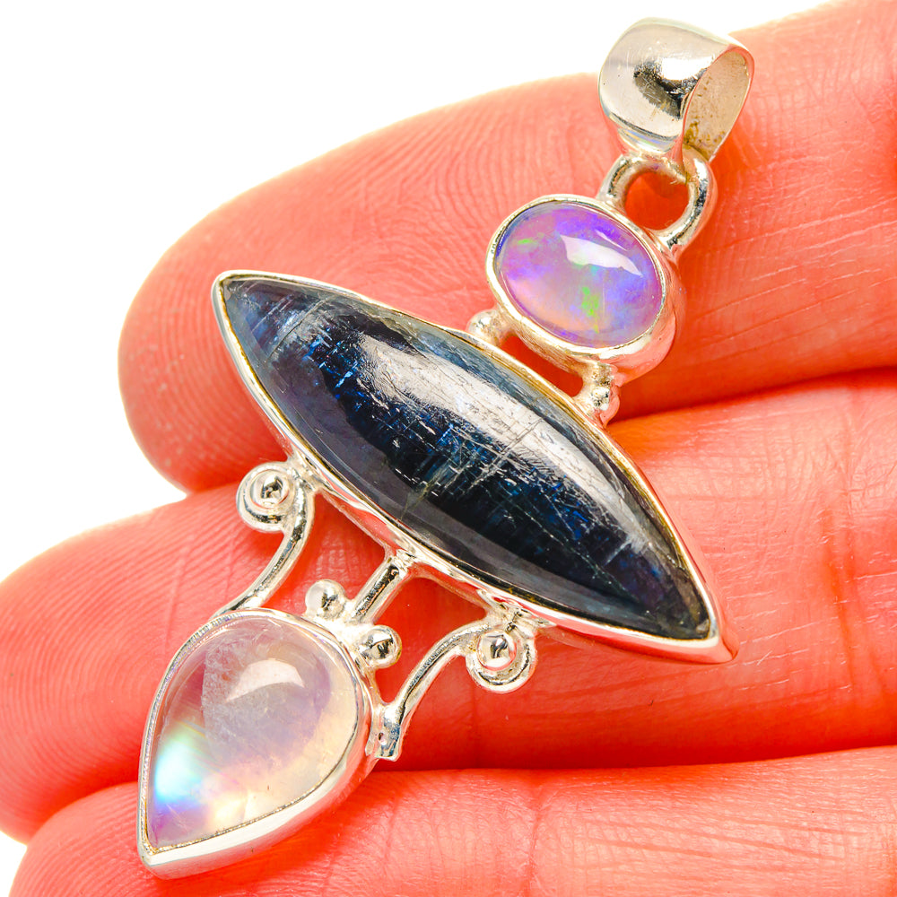 Pendant with blue teardrop stone and purple iridescent cabochon drops in silver-tone setting