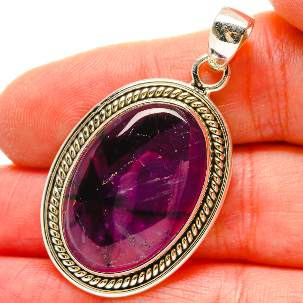 Star amethyst pendant in dark purple oval sterling silver setting with star sparkle
