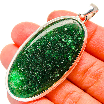 Green aventurine oval cabochon pendant in sterling silver bezel, shown on fingers