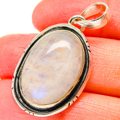 Oval moonstone pendant in 925 sterling silver with iridescent cabochon and black bezel