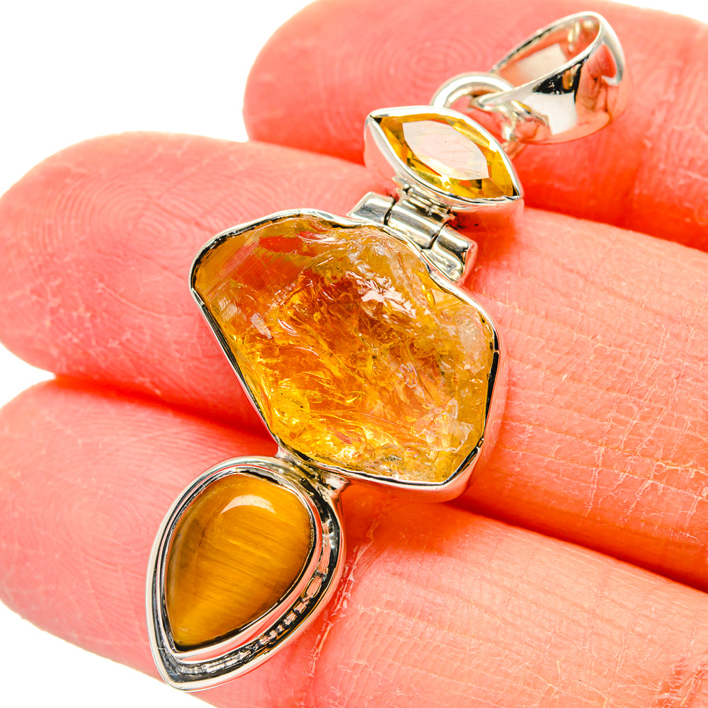 Sterling silver pendant showing amber square stone and two golden oval cabochons