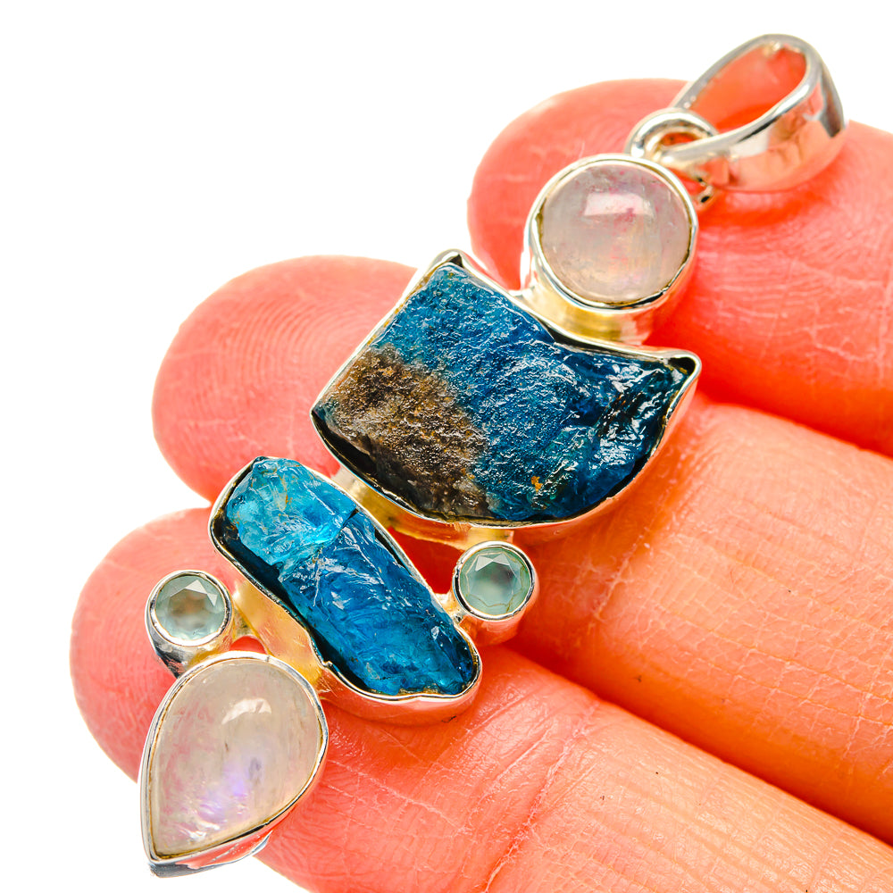 Sterling silver pendant with rough blue gemstone and round iridescent stones
