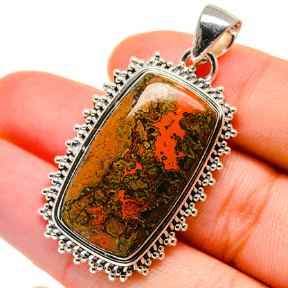 Rectangular gemstone pendant with red and green mottled pattern in silver bezel