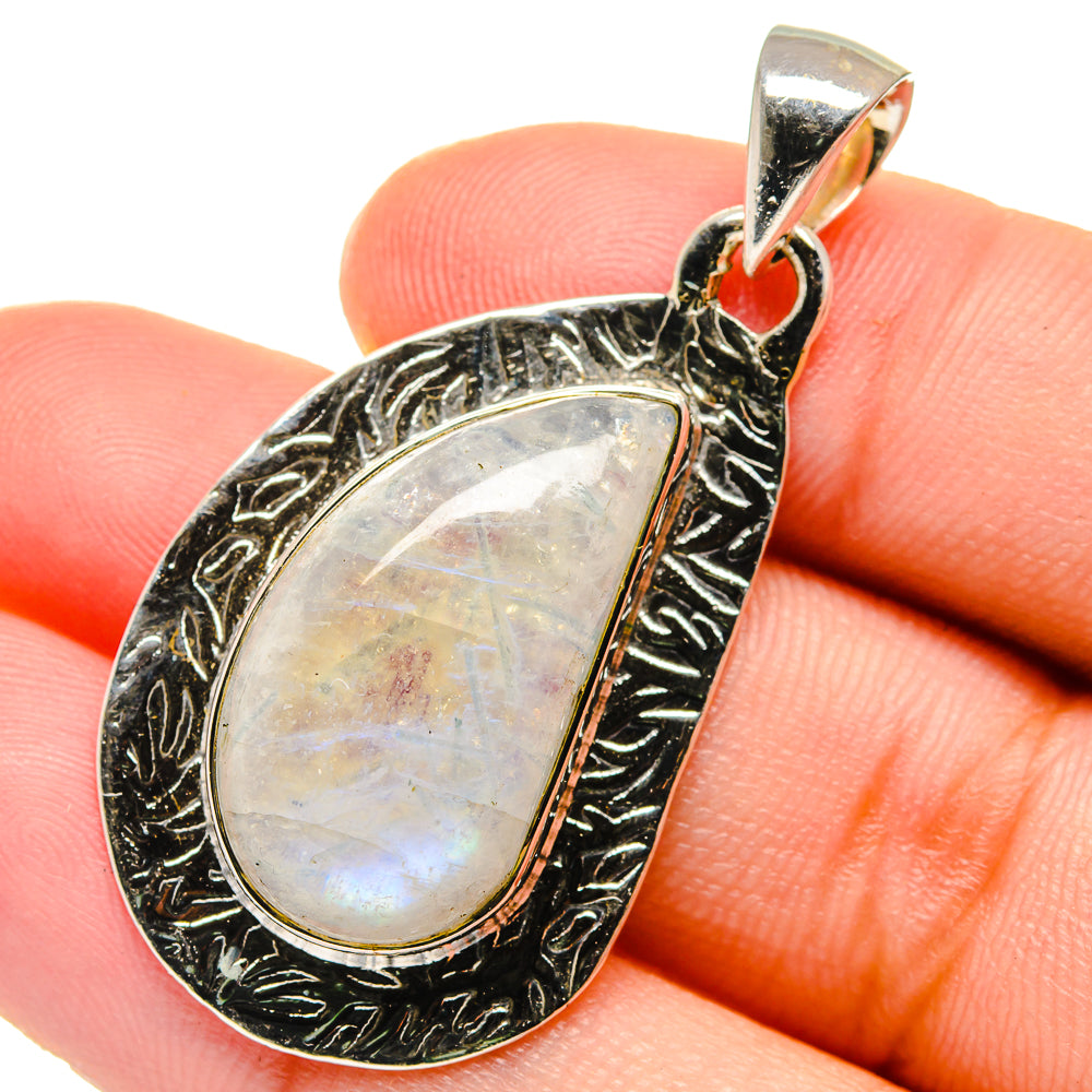 Sterling silver teardrop pendant with iridescent rainbow moonstone, ornate frame and bail