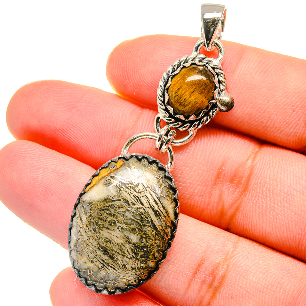 Sterling silver pendant closeup: amber tiger eye round top with textured oval pyrite agate