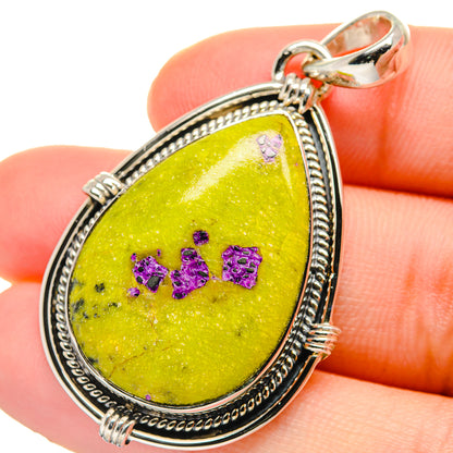 Sterling silver teardrop pendant with bright yellow stone and purple glittery details