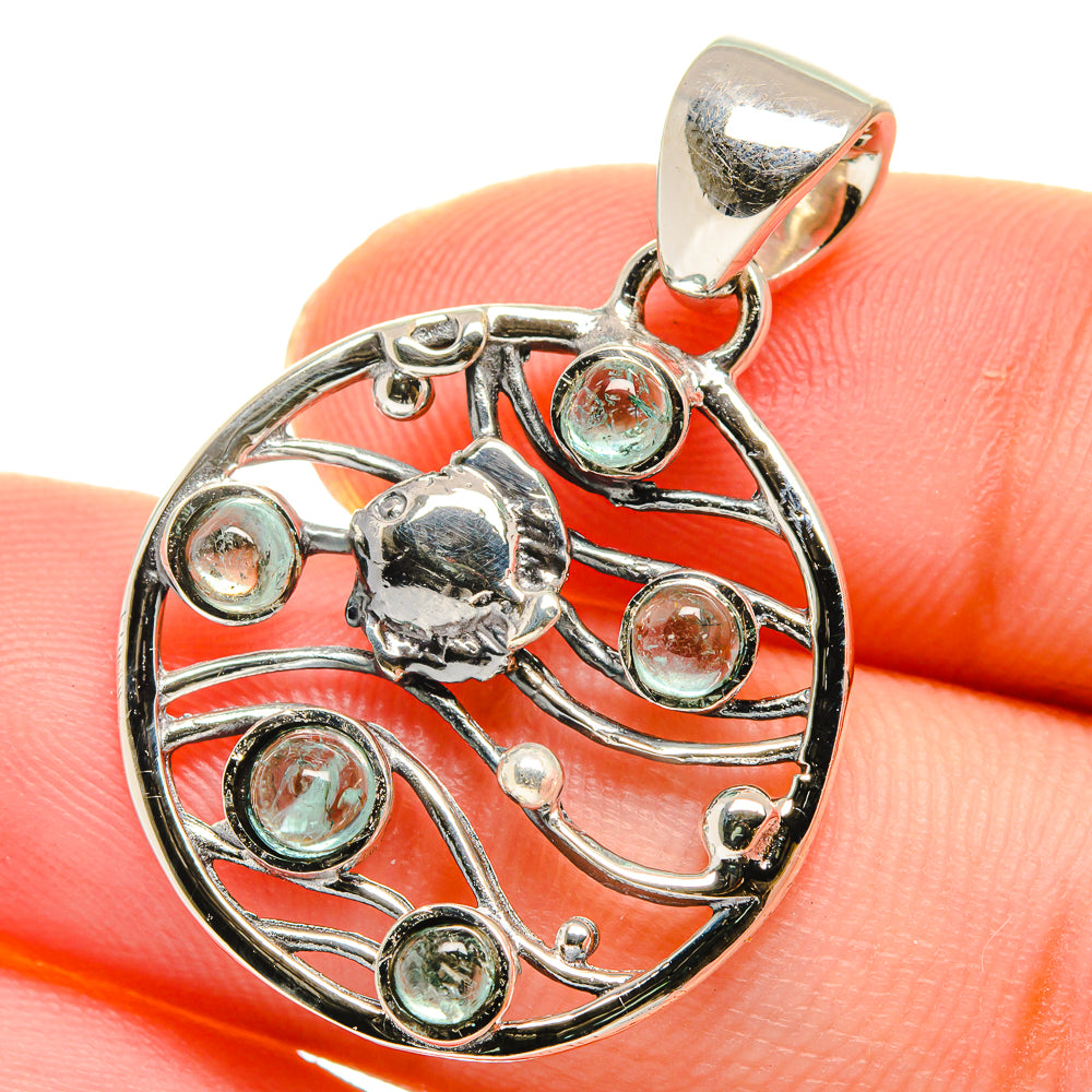 Aquamarine pendant in sterling silver, round cabochon in ornate circular filigree.