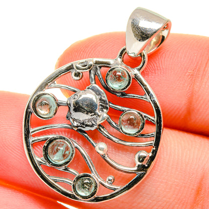 Aquamarine pendant in sterling silver, round cabochon in ornate circular filigree.