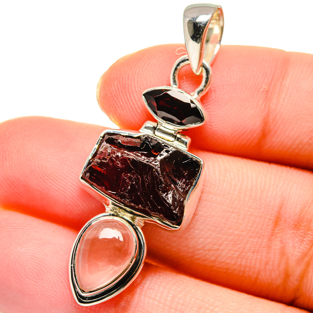 Sterling silver pendant closeup with rough black-red gem and pink rose quartz drop