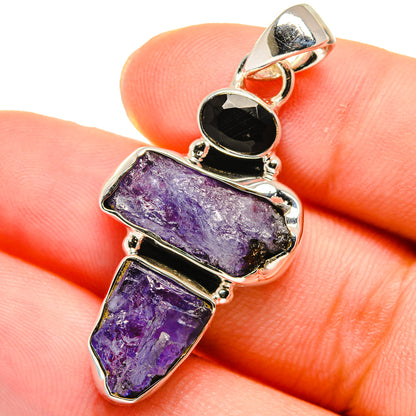 Rough tanzanite and black onyx pendant, sterling silver setting, round onyx top bail