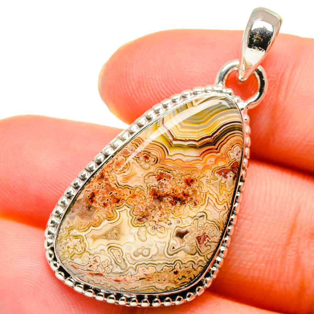 Lace agate teardrop pendant in 925 sterling silver with faceted pattern and bail.