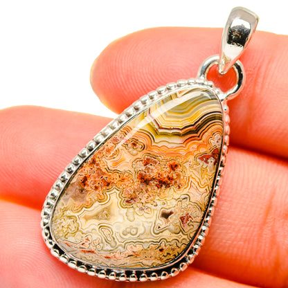 Lace agate teardrop pendant in 925 sterling silver with faceted pattern and bail.