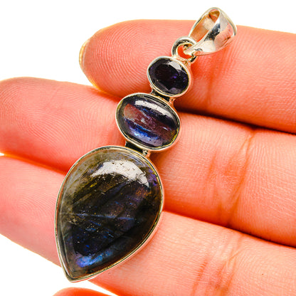 925 sterling silver pendant close-up with iridescent teardrop center and dark blue oval stones