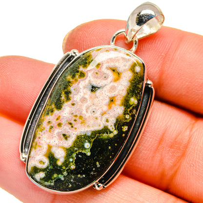 Ocean jasper pendant with oval green-and-white stone in sterling silver bezel bail