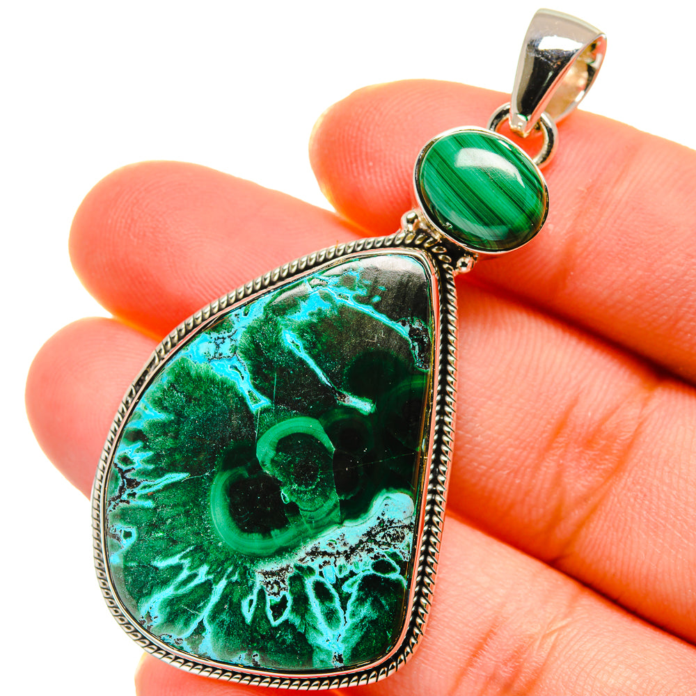 Close-up teardrop sterling silver pendant with green malachite stone and top bail