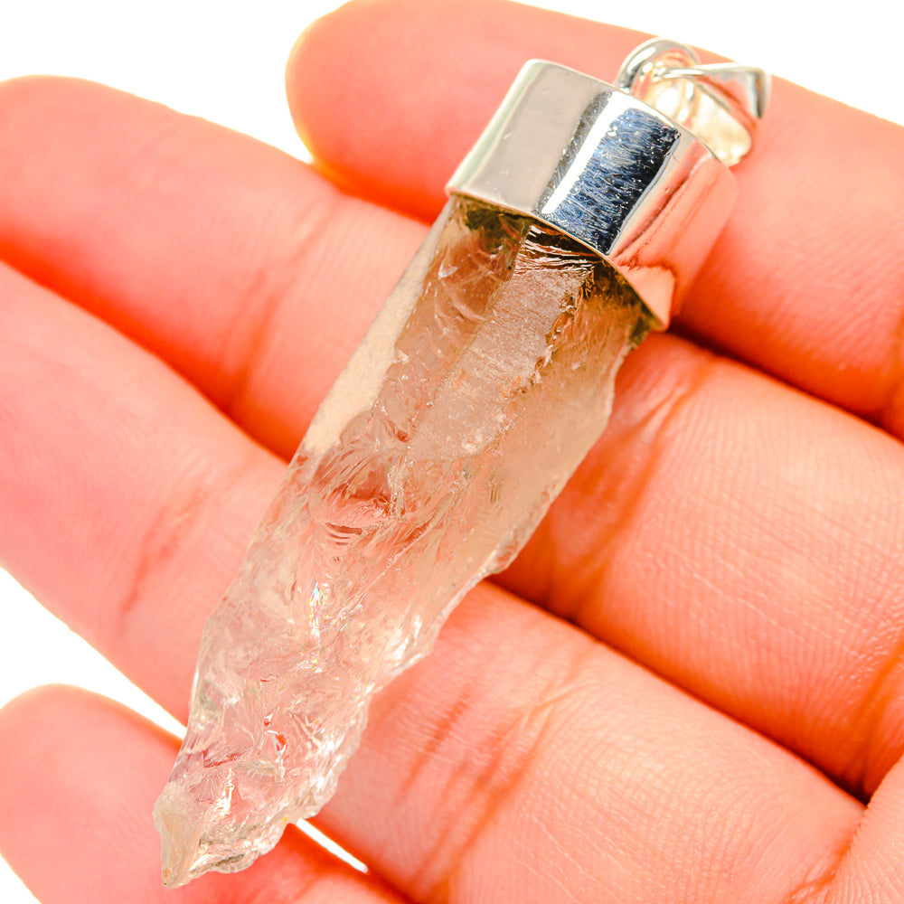 Sterling silver moonstone pendant with rough clear crystal and bezel bail, close-up