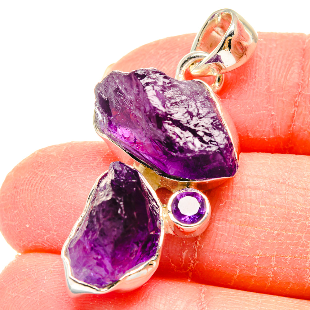 Rough amethyst pendant in sterling silver with faceted purple crystals and round side stone