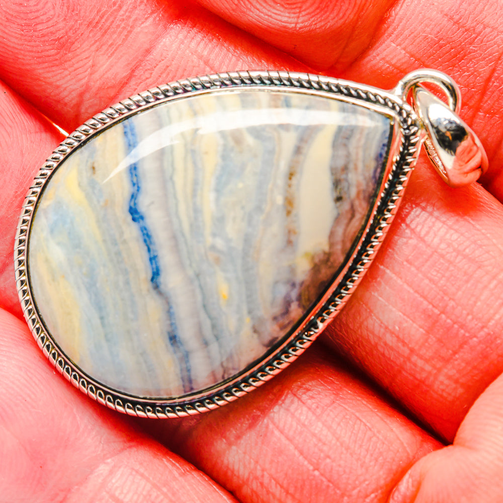 Teardrop blue scheelite pendant close-up, sterling silver rope bezel and bail loop