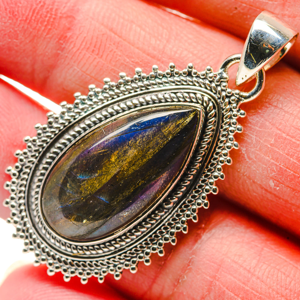 Close-up oval labradorite cabochon pendant, blue flash stone in beaded silver bezel