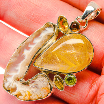 Yellow citrine quartz pendant with oval gemstone center, small green peridot drops, silver loop
