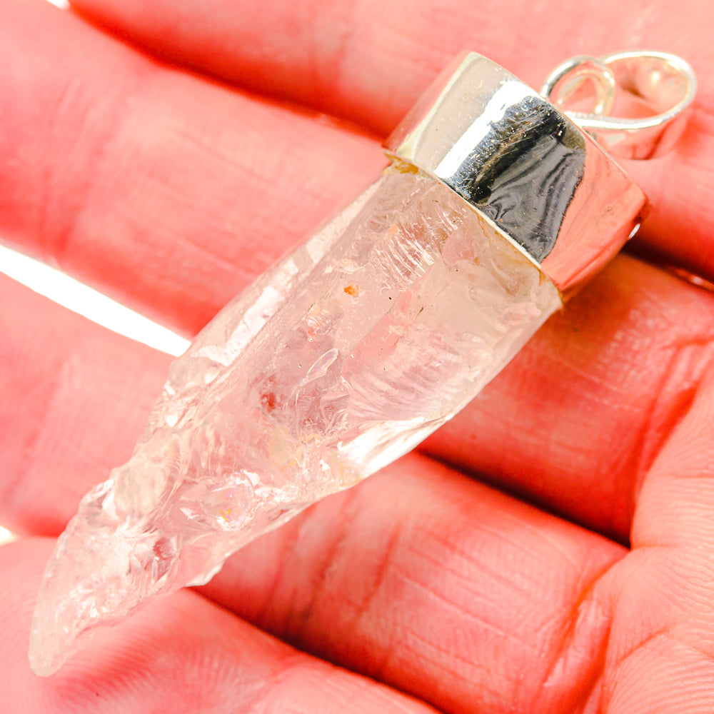 Rough rainbow moonstone pendant with polished 925 silver bail and translucent pale stone