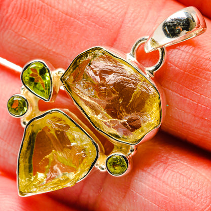 Sterling silver lemon quartz and peridot pendant close-up on yellow faceted stones