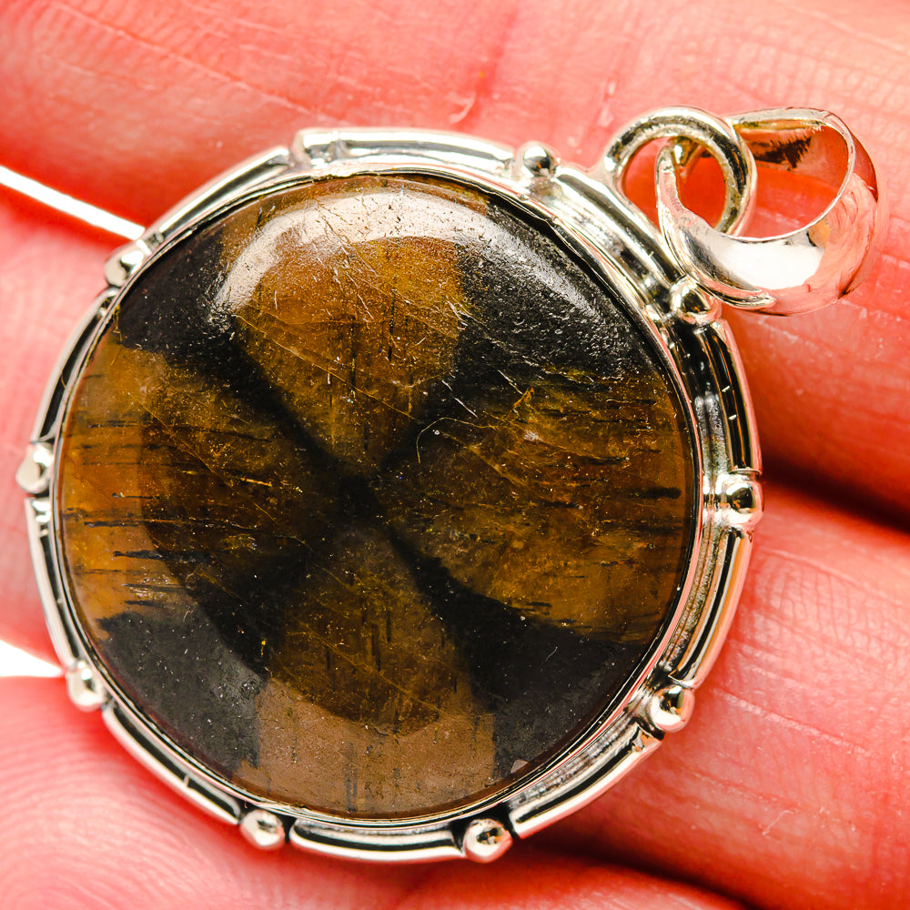 Round chiastolite pendant, 925 sterling silver bezel, golden-brown stone close-up